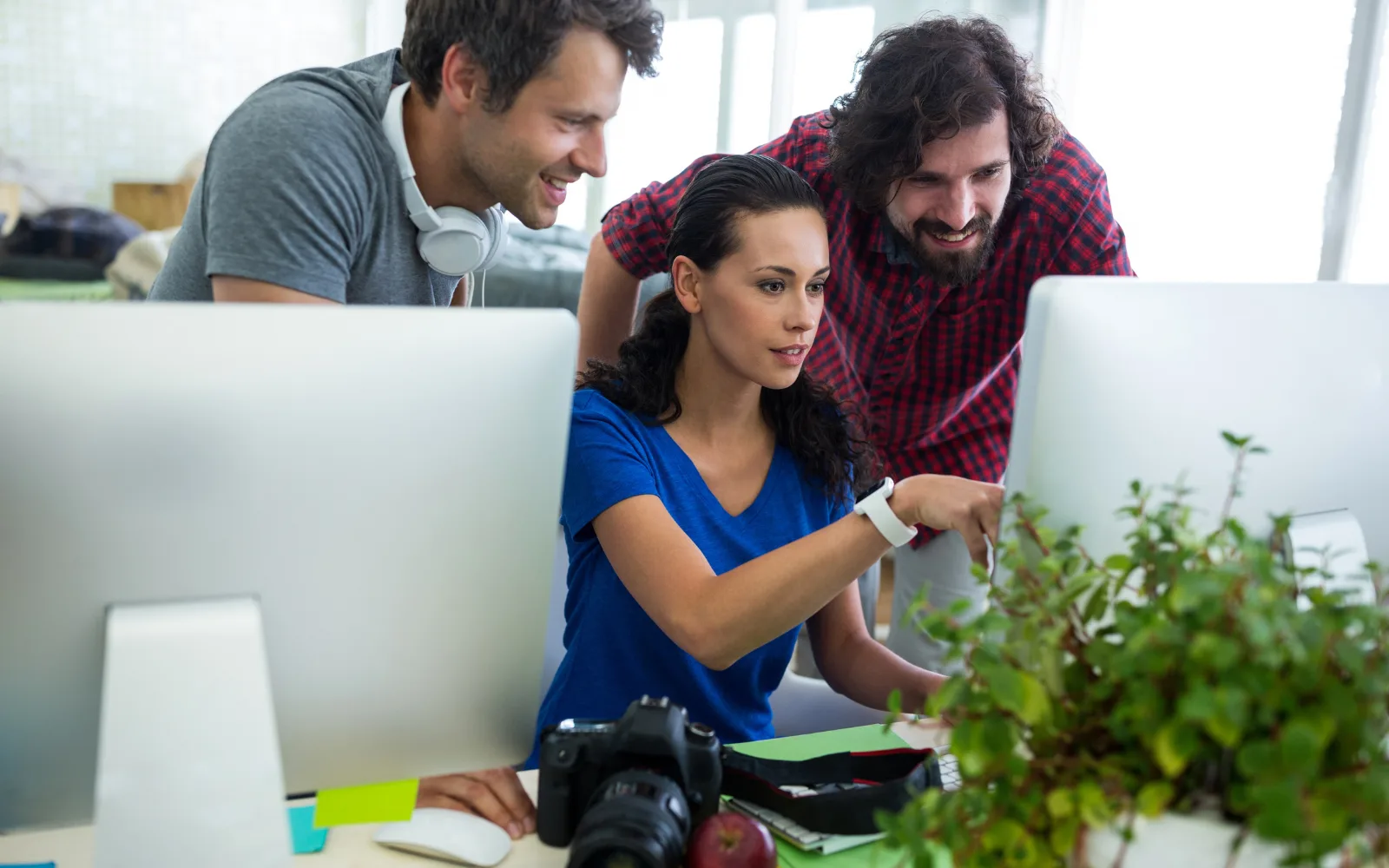 Team planning SEO strategy with laptops and whiteboard charts